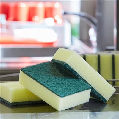 Heavy-duty sponge scourers in green and yellow, ideal for tough cleaning tasks.