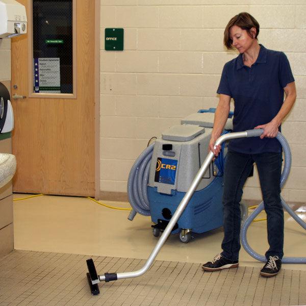 Person using a Prochem CR2 Multi-Surface Cleaning Machine in a hallway.