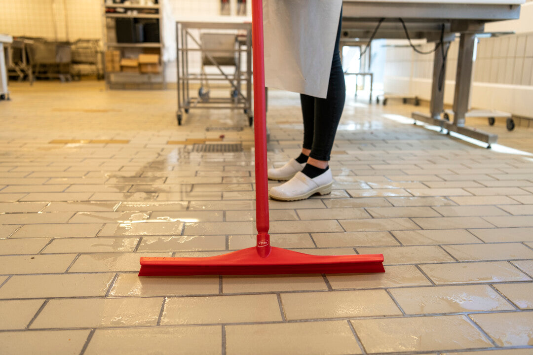 Vikan Ultra Hygiene Squeegee 600mm Red – food-safe floor cleaning tool in use.
