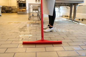 Vikan Ultra Hygiene Squeegee 600mm Red – food-safe floor cleaning tool in use.