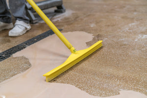 Vikan Ultra Hygiene Squeegee 600mm Yellow on a wet floor, designed for food safety.