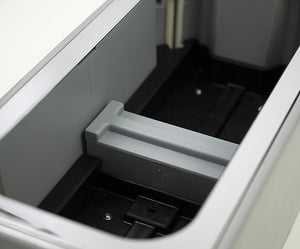 Interior view of the Automatic Shoe Cover Dispenser AD1, showing the cover storage area.