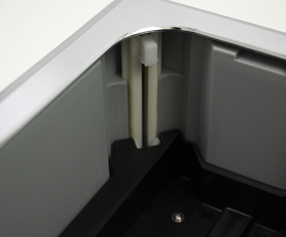 Interior view of the Automatic Shoe Cover Dispenser AD1 showing the cover mechanism.