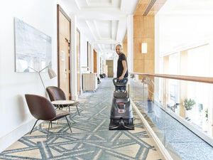 Viper CEX410 Carpet Extraction Machine in a hotel hallway, being operated by a worker.