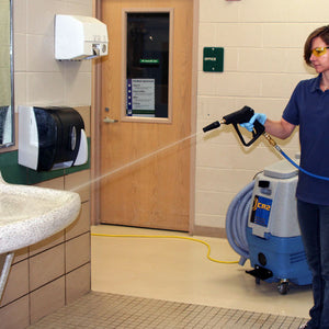 Person using a Prochem CR2 Multi-Surface Cleaning Machine in a restroom.
