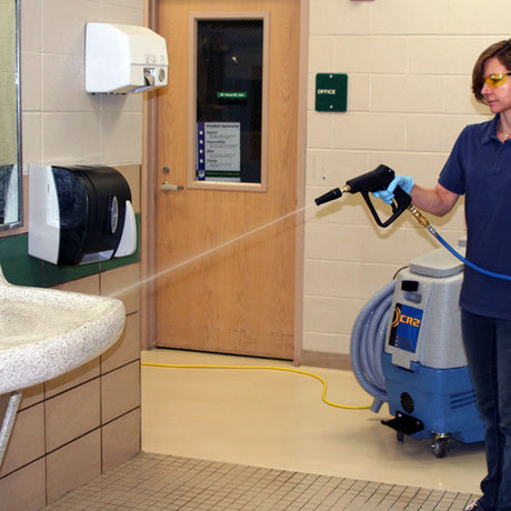 Person using a Prochem CR2 Multi-Surface Cleaning Machine in a restroom.