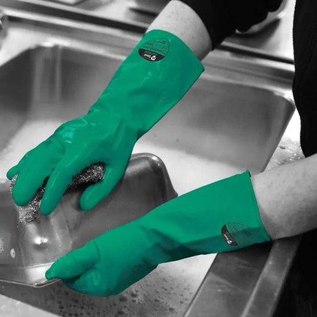 Reusable Household Rubber Gloves in green, shown being used for cleaning dishes.