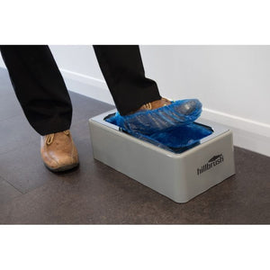 Automatic Shoe Cover Dispenser AD1 - DG115 in use, applying a blue cover to a shoe.