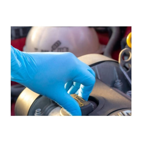 Person wearing Jangro Blue Nitrile Gloves, checking an engine component.