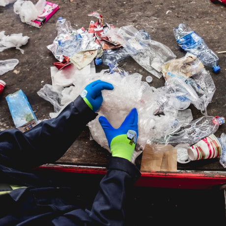 Person wearing HexArmor PointGuard Ultra Gloves while sorting through plastic waste.
