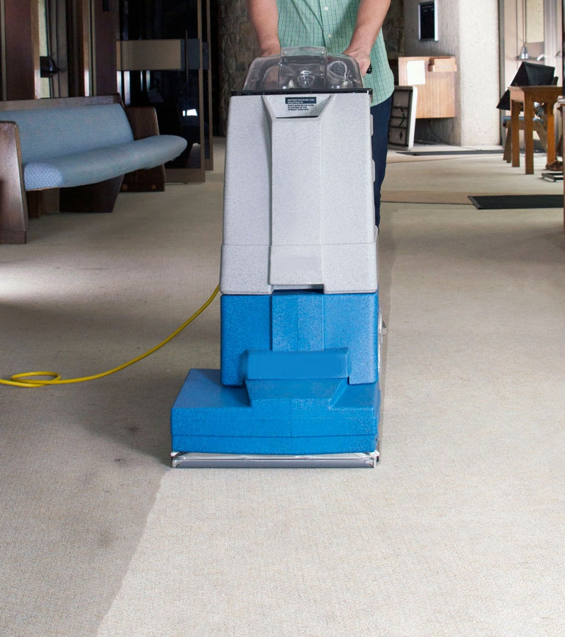 Polaris SP800 Carpet Cleaner in use on carpeted floor, with power cord visible.