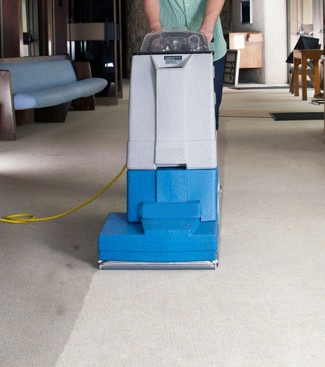 Polaris SP800 Carpet Cleaner in use on carpeted floor, with power cord visible.