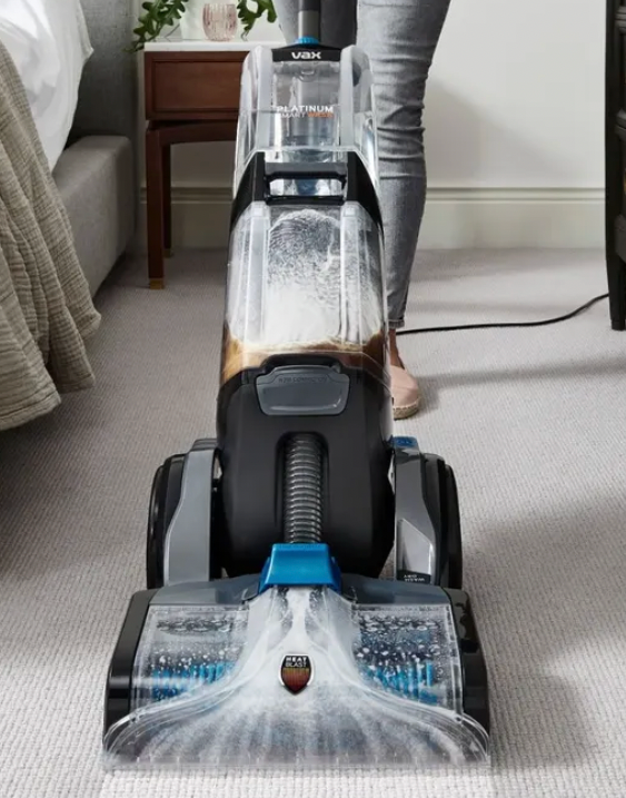 Vax Platinum SmartWash Carpet Cleaner in use on carpet, showing cleaning action.