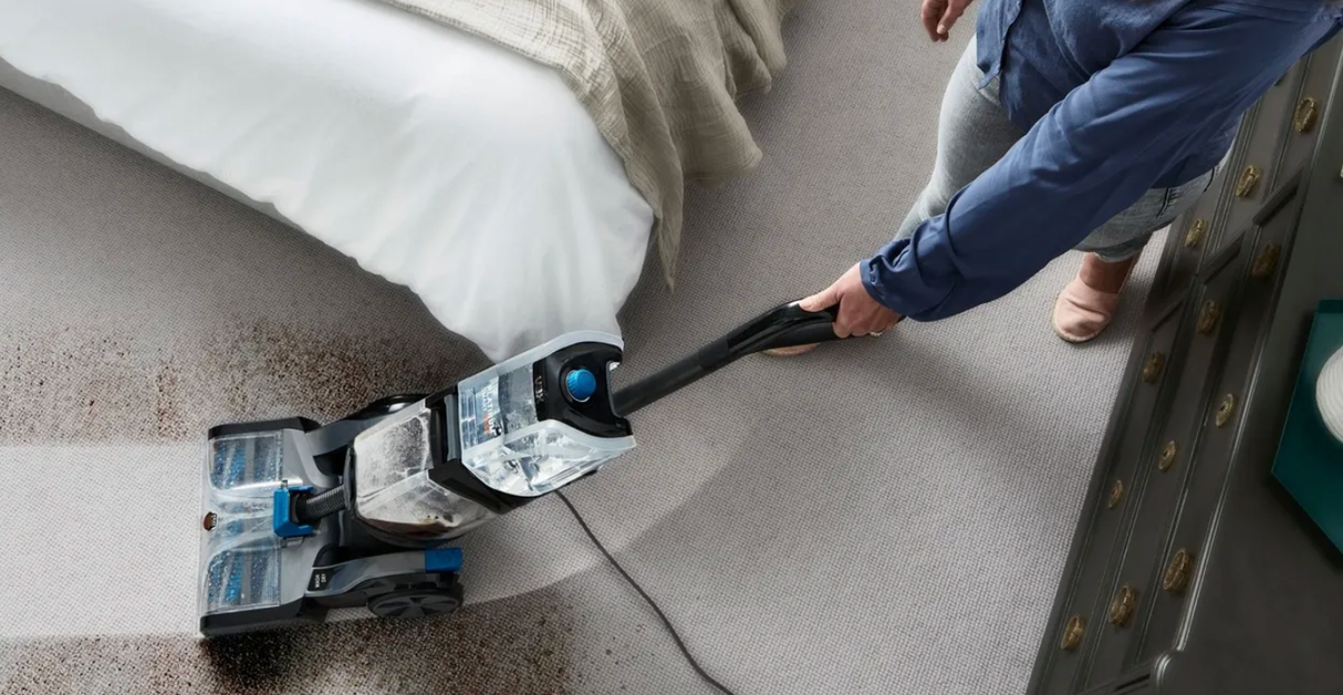 Vax Platinum SmartWash Carpet Cleaner in use on a carpet with stains.