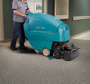 Tennant ReadySpace 1610 Carpet Cleaner in use on carpeted hallway.